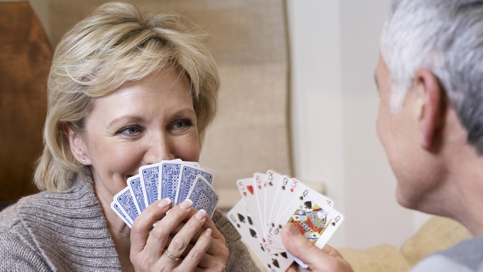 Middle-aged couple playing cards