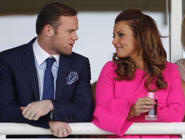 LIVERPOOL, ENGLAND - APRIL 12:  Manchester United football player Wayne Rooney and his wife Coleen watch the racing during the first day of the Aintree Grand National meeting on April 12, 2012 in Aintree, England. The first day, known as Liverpool Day, celebrates the city's link with the famous Aintree Racecourse.  (Photo by Christopher Furlong/Getty Images)