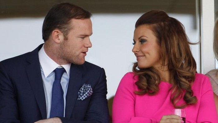 LIVERPOOL, ENGLAND - APRIL 12:  Manchester United football player Wayne Rooney and his wife Coleen watch the racing during the first day of the Aintree Grand National meeting on April 12, 2012 in Aintree, England. The first day, known as Liverpool Day, celebrates the citys link with the famous Aintree Racecourse.  (Photo by Christopher Furlong/Getty Images)