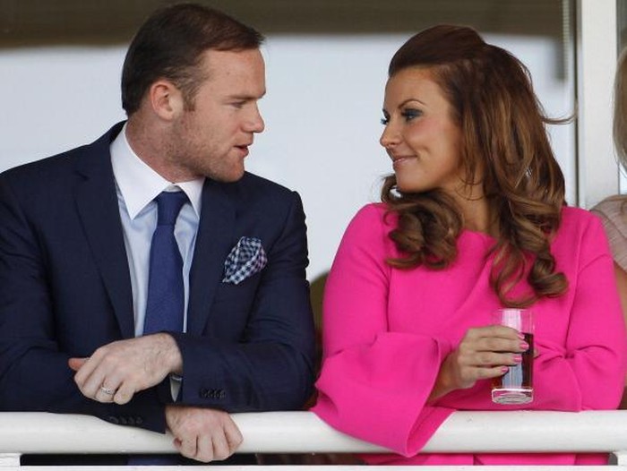 LIVERPOOL, ENGLAND - APRIL 12:  Manchester United football player Wayne Rooney and his wife Coleen watch the racing during the first day of the Aintree Grand National meeting on April 12, 2012 in Aintree, England. The first day, known as Liverpool Day, celebrates the citys link with the famous Aintree Racecourse.  (Photo by Christopher Furlong/Getty Images)