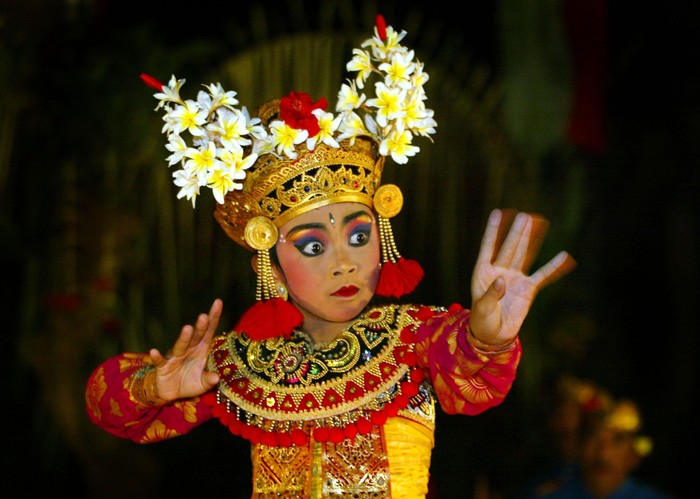 UBUD, BALI, INDONESIA - AUGUST 6:   Meri Nirmala Sari, 11, performs a Legong Kraton dance for tourists August 6, 2002 in Ubud, Bali, Indonesia. Meri dances with the Gunung Sari Peliatan dance group and has become professional. She started dancing at age 5. Music, dance and drama are all closely related in Bali and are essential part of the colorful Balinese culture. Legong dance is the center of classical female Balinese dancing. The dance has no less than 92 movements and is performed for both religious reasons and for entertainment. Many Balinese girls learn the art as a way of making a living performing for tourists. (Photo by Paula Bronstein/Getty Images)