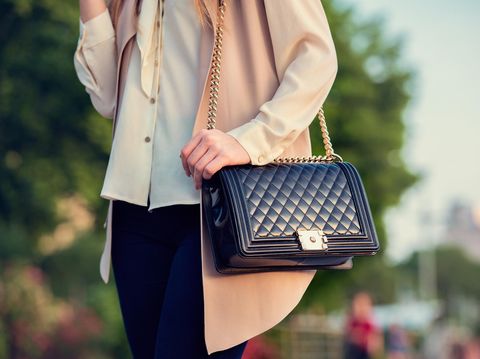 537541640 Woman carrying elegant purses bag at city park