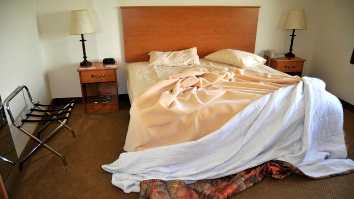 Bed sheet mattress Duvet and pillows unmade Bedroom interior