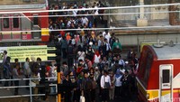 Warga turun dari Commuter Line yang membawa mereka ke Stasiun Tanah Abang.