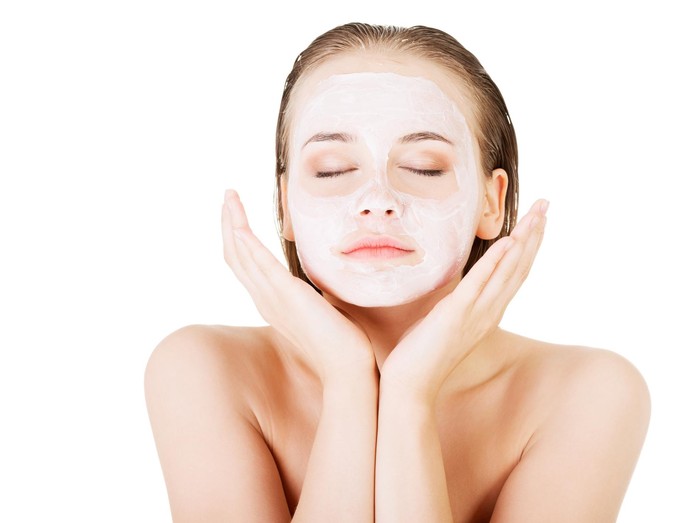 462860157 Beautiful woman with clay facial mask, isolated on white