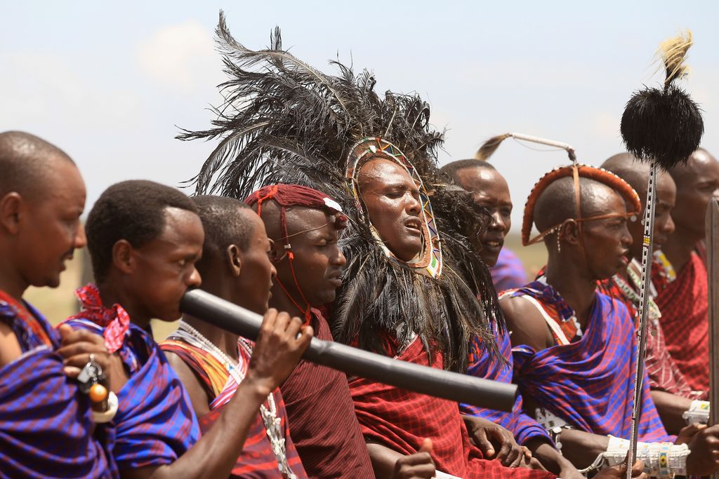 ARUSHA, TANZANIA - NOVEMBER 09:  Maasai men prepare to greet Camilla, Duchess of Cornwall and Prince Charles, Prince of Walesas they visit  Majengo Maasai Boma on November 9, 2011 in Arusha, Tanzania. The Prince of Wales and the Duchess of Cornwall are on the final day of a four day tour of Tanzania after a successful trip to South Africa. The Royal couple will be highlighting environmental and social issues during their visit to Africa.  (Photo by Chris Jackson/Getty Images)