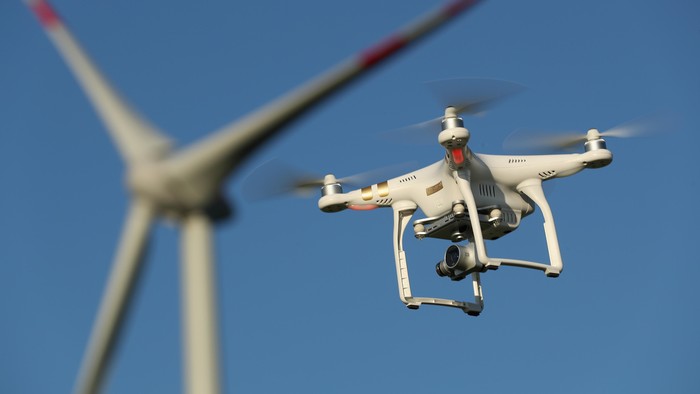 BRUECK, GERMANY - JUNE 08:  The photographers DJI Phantom 3 Pro multirotor drone flies near a wind farm on June 8, 2016 near Brueck, Germany. Countries across Europe are debating legislation to regulate the use of consumer drones. As prices have come down and piloting simplified the market for consumer-oriented drones has risen dramatically with sales of hundreds of thousands of drones expected for coming years.  (Photo by Sean Gallup/Getty Images)