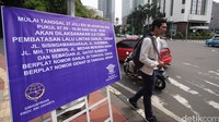 Papan informasi uji coba penerapan sistem lalu lintas plat Ganjil Genap terpampang di Jalan Underpas Dukuh Atas, Sudirman, Jakarta, Senin (25/7/2016).