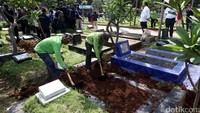 Petugas dinas Pertamanan dan Pemakaman DKI Jakarta membongkar makam fiktif di TPU Menteng Pulo, Jakarta, Kamis (28/7/2016).