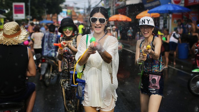 BANGKOK, THAILAND - JANUARY 28:  A Ukrainian tourist shops in the street fair zone between the protest sites January 28, 2014 in Bangkok, Thailand. Caretaker Prime Minister Yingluck Shinawatra said the general elections set for February 2, will go forward as planned. The 