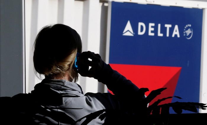 FILE PHOTO - A passenger talks on her phone at a Delta Airlines gate a day before the annual Thanksgiving Day holiday at the Salt Lake City international airport, in Salt Lake City, Utah November 21, 2012.    REUTERS/George Frey/File Photo