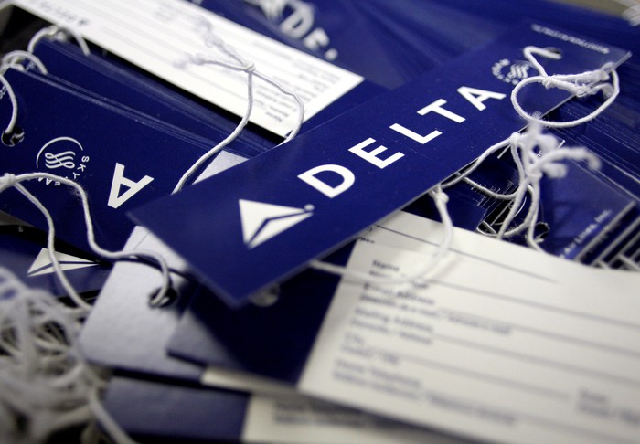 Delta airline name tags are seen at Delta terminal in JFK Airport in New York, July 30, 2008. REUTERS/Joshua Lott/File Photo