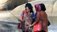 Wisatawan menikmati pemandangan pantai Tanjung Tinggi, yang terletak di Kecamatan Sijuk, Kabupaten Belitung, Bangka Belitung, Rabu (10/8/2016). 