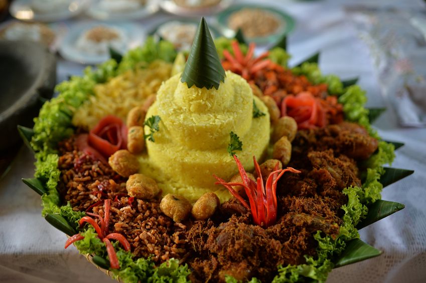 Tumpeng is a cone-shaped rice dish like mountain with its side dishes (vegetables and meat). Traditionally featured in the slamatan ceremony, the cone shape of rice is made by using cone-shaped woven bamboo container. The rice itself could be plain steamed rice, uduk rice (cooked with coconut milk), or yellow rice (uduk rice colored with kunyit (turmeric)).