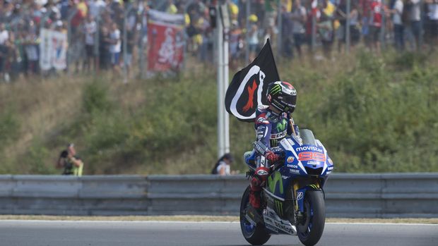 BRNO, CZECH REPUBLIC - AUGUST 16:  Jorge Lorenzo of Spain and Movistar Yamaha MotoGP celebrates the victory with flag at the end of the MotoGP race during the MotoGp of Czech Republic - Race at Brno Circuit on August 16, 2015 in Brno, Czech Republic.  (Photo by Mirco Lazzari gp/Getty Images)