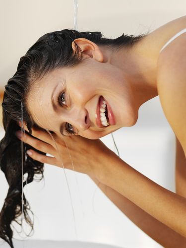 Close-up of a woman rinsing her hair