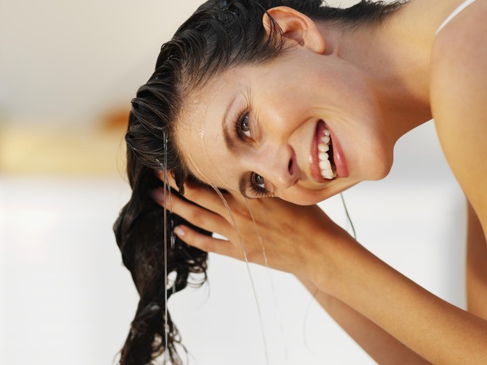 Close-up of a woman rinsing her hair