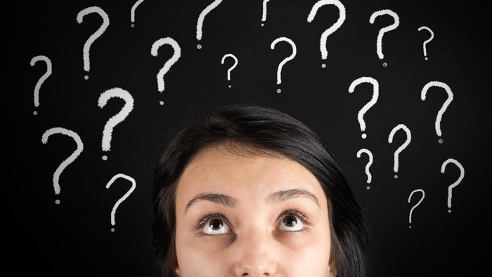 Ilustrasi Wanita Bingung Confused woman and question marks high quality studio shot
