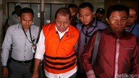 Amran berjalan menuju mobil tahanan KPK.