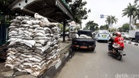 Karung-karung berisi lumpur ditumpuk sebelum dibuang.