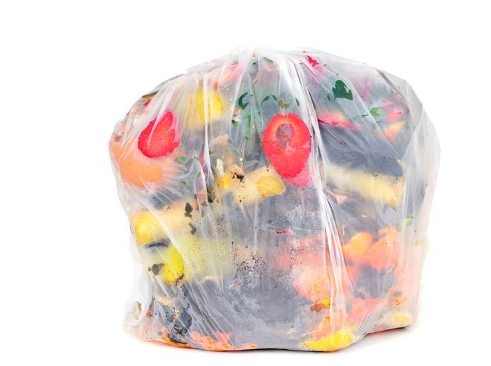 a biodegradable bag full of biodegradable waste on a white background