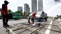 Sementara tiang rambu lalu lintas yang roboh tampak dipotong-potong.
