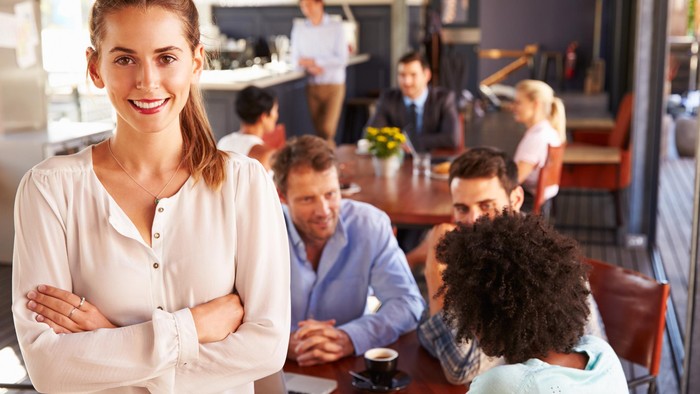 1133804313 Multi ethnic group of professionals at a coworking office in a meeting discussing something looking focused