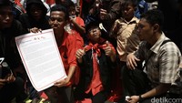 Demonstran menunjukkan surat yang akan diserahkan kepada Ketum PDIP Megawati Soekarnoputri.