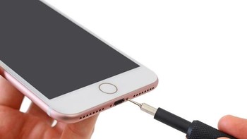 Proses awal membongkar iPhone 7 Plus dimulai dari membuka sekrup yang terletak di dua sisi port lightning. Foto: istimewa/ifixit