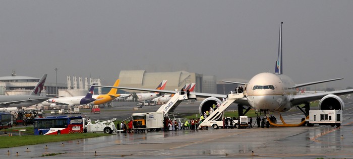 Passengers disembark from a Saudi Arabia Airlines plane parked at the tarmac of Ninoy Aquino International airport in Pasay city, Metro Manila, Philippines September 20, 2016.  REUTERS/Erik De Castro