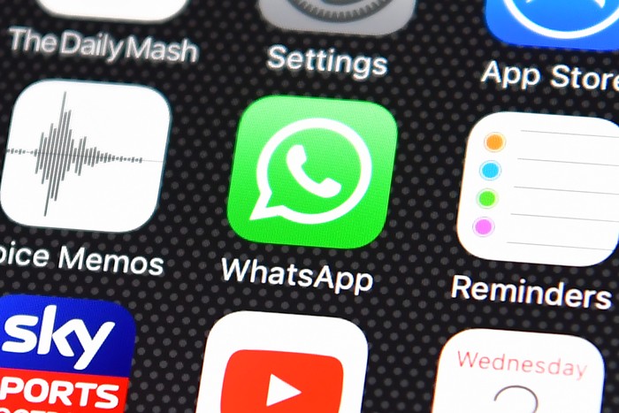LONDON, ENGLAND - AUGUST 03:  A persons finger is posed next to the Whatsapp app logo on an iPhone on August 3, 2016 in London, England.  (Photo by Carl Court/Getty Images)