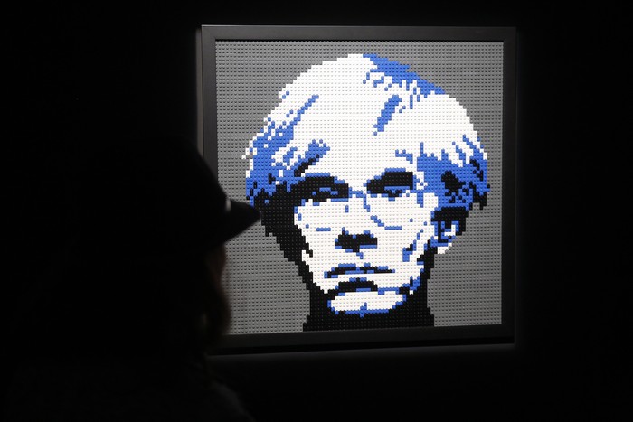 Andy Warhol PARIS, FRANCE - MAY 15: A visitor looks at a sculpture showing a portait of Andy Warhol made with Lego bricks by US artist Nathan Sawaya during the exhibition