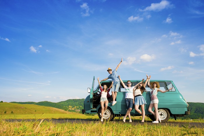 Young hipster friends on road trip on a summers day