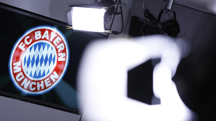 MUNICH, GERMANY - MARCH 14: A club logo is seen behind TV lights during a press conference at the offices of German football club FC Bayern following the announcement by Uli Hoeness that he has resigned as club governing board chairman and will not appeal the three and half year jail sentence handed down by a Munich court the day before on March 14, 2014 in Munich, Germany. A judge found Hoeness guilty of evading taxes totaling at least EUR 27.2 million and declared his pre-emptive attempt at turning himself in to German tax authorities as invalid. Hoeness has been a pillar in German football club history, beginning with his career as a stellar professional player with FC Bayern in the 1970s to his role as FC Bayern club chairman, during which the Bundesliga team has been among the most successful in Germany.  (Photo by Philipp Guelland/Getty Images)