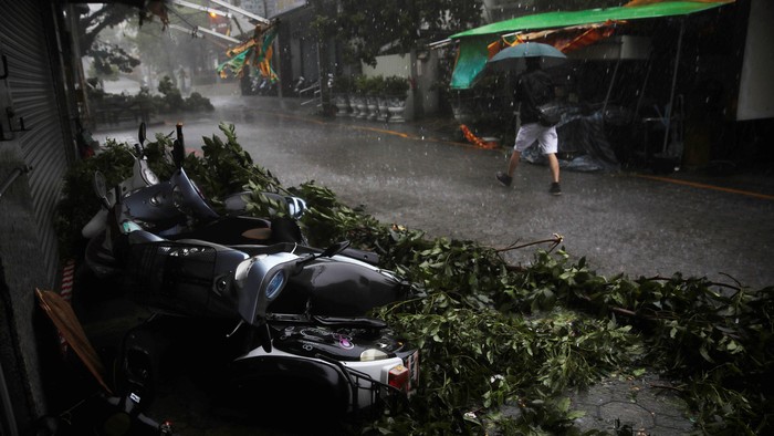 A motorcyclist rides past advertisement banners damaged by Typhoon Megi in Hualien, eastern Taiwan September 27, 2016. REUTERS/Tyrone Siu