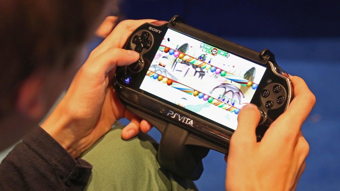 COLOGNE, GERMANY - AUGUST 22:  A gaming enthusiast tries out a Sony Playstation Vita game at the Gamescom 2013 gaming trade air on August 22, 2013 in Cologne, Germany. Gamescom is the worlds largest trade fair for digital gaming and will be open to the public from August 22-25.  (Photo by Juergen Schwarz/Getty Images)