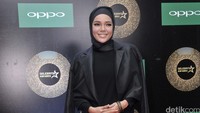 Dewi Sandra tampil mengenakan busana muslim serba hitam yang trendy.