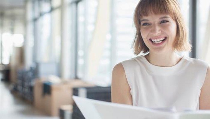 Businesswoman laughing in office