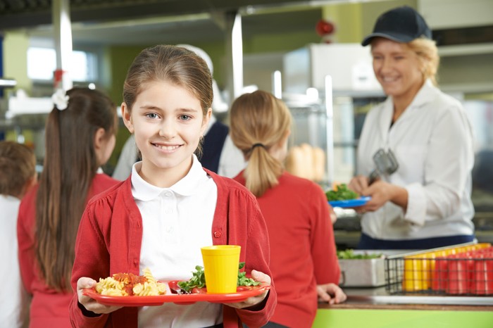 Female Pupil With Healthy Lunch In School Cafeteria