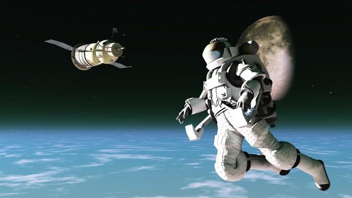 Spacesuited astronaut with satellite in low orbit
