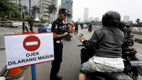 Petugas keamanan membantu mengatur lalu lintas.
