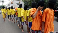 Para tersangka dihadirkan dalam rilis dengan tangan diborgol.