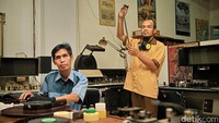 Firdaus (kiri) dan Budi Ismanto (kanan) membersihkan gulungan film di ruang kerjanya di Sinematek Indonesia, Gedung Usmar Ismail, Jakarta. Keduanya menjaga ribuan gulungan film dari berbagai judul supaya tetap bersih dan bisa diputar. 