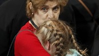 Lagi, seorang ibu memeluk erat sang anak saat perolehan suara Hillary tertinggal dari Trump. REUTERS/Shannon Stapleton.