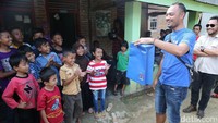 Anak-anak dihibur oleh aksi sulap dari peserta Datsun Risers Expedition (DRE).