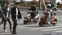 Skuter listrik melintas di jalanan di kota Suzhou.