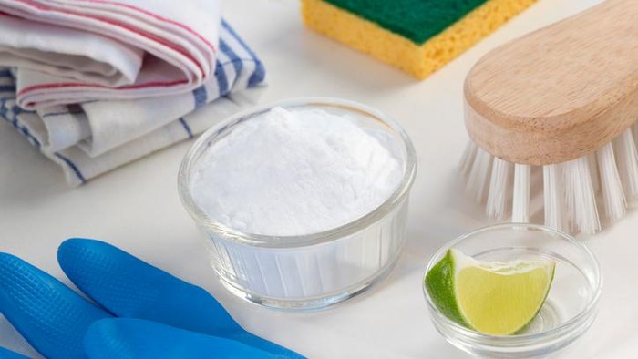 Eco-friendly natural cleaners Vinegar, baking soda, salt, lemon and cloth on wooden table Homemade green cleaning