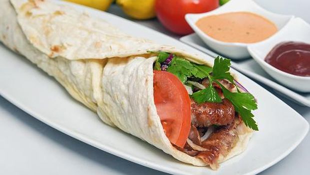 Close-Up Of Fresh Kebab Shawarma Served In Plate With Savory Sauces
