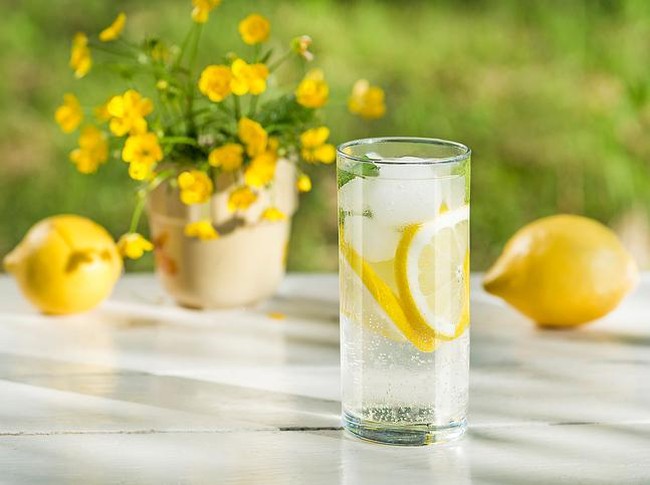 Lemon infused water with mint in glasses and jug.Healthy drink, detox, dieting beverage.