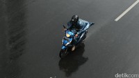 Seorang pemotor memacu sepeda motornya karena jalanan kosong.